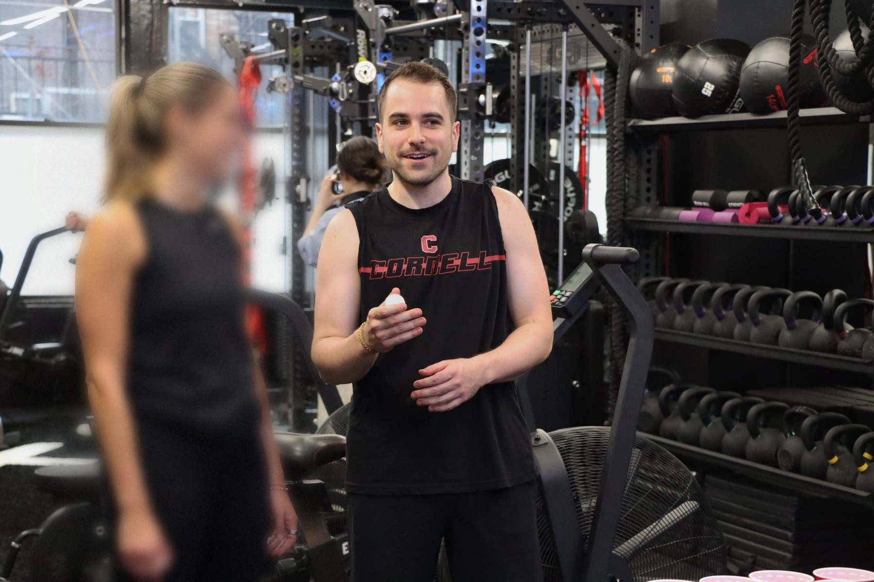 Josh Popkin training at the gym in a Cornell tank top
