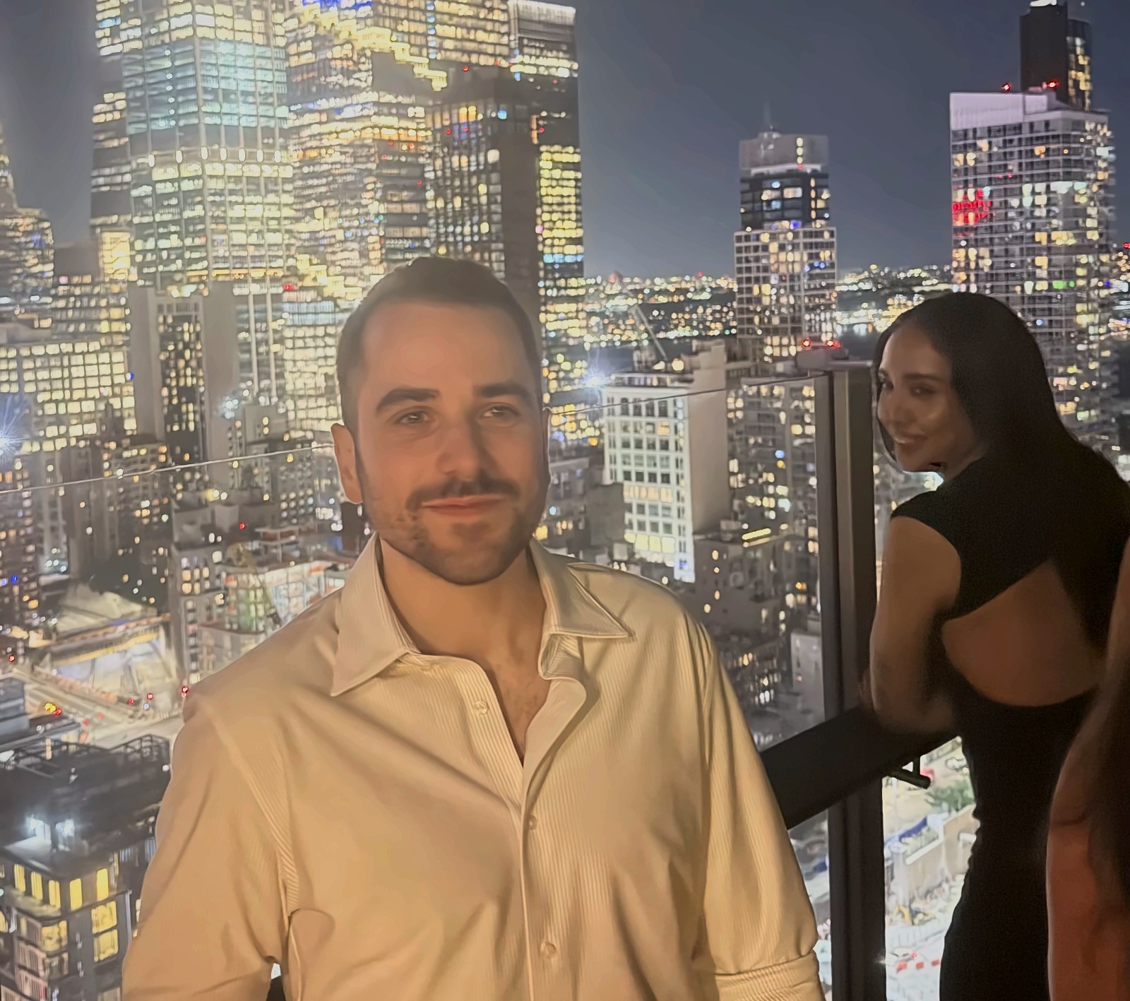 Josh Popkin on a Manhattan rooftop overlooking the New York City skyline