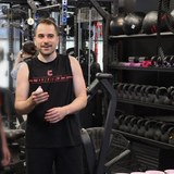 Josh Popkin training at the gym in a Cornell tank top