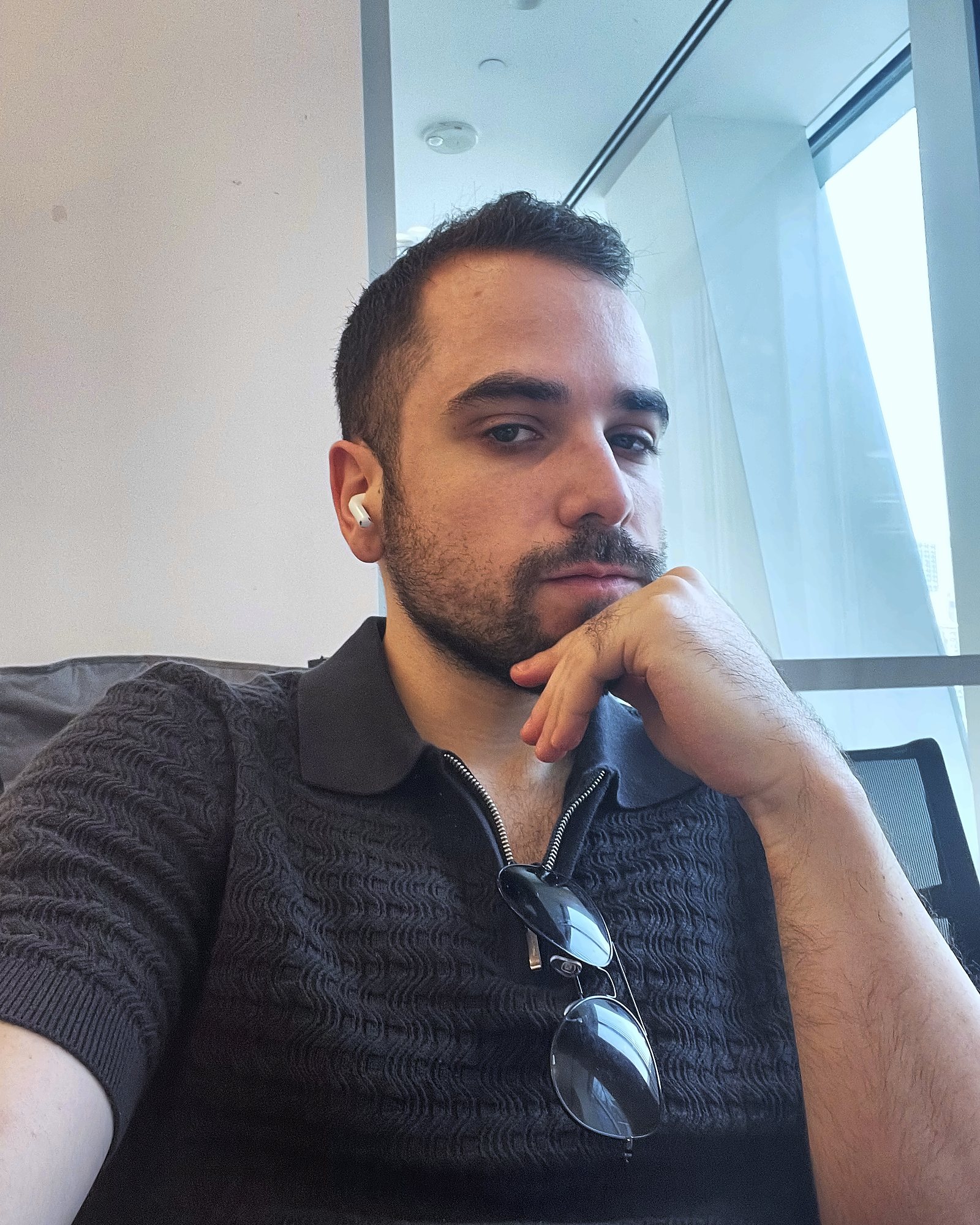 Josh Popkin seated in a Manhattan office, chin resting on his hand